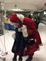 Neveah gives Santa a big hug in thanks for her new coat.